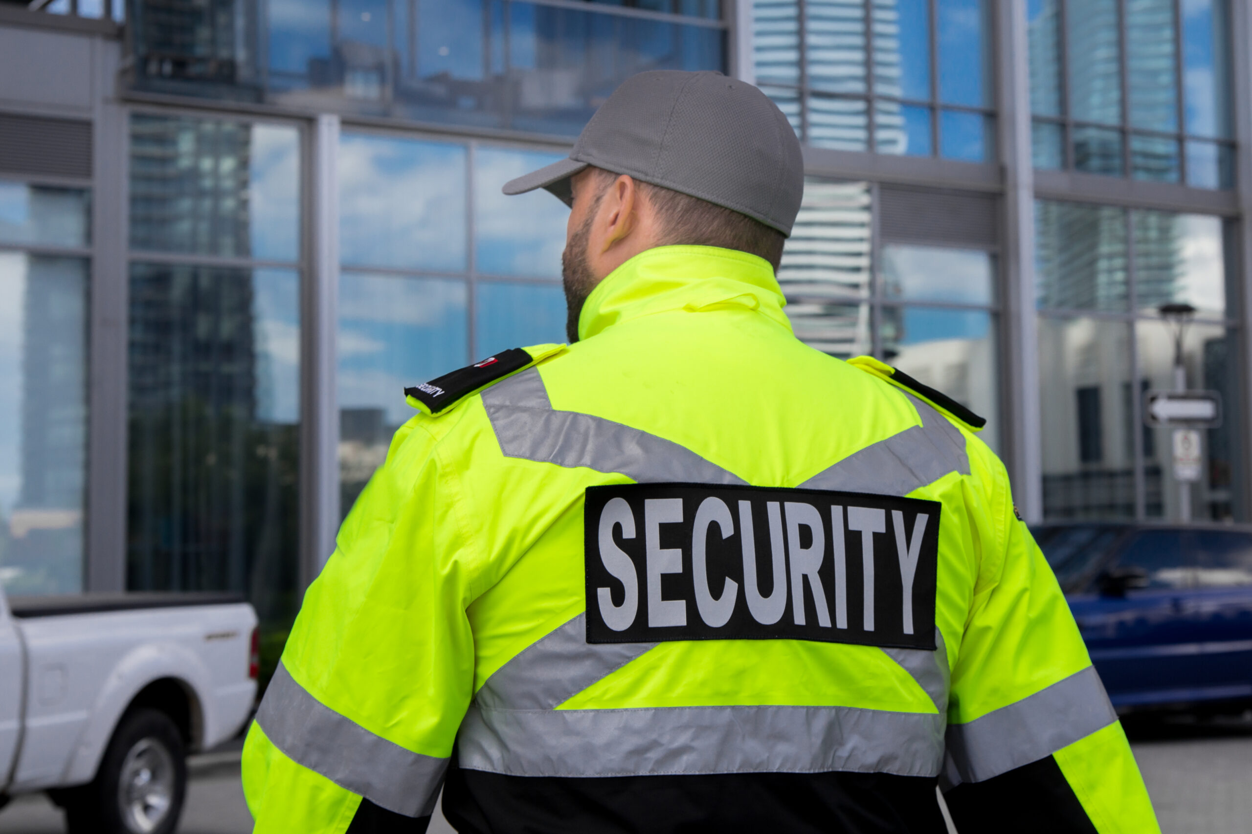 A security guard in uniform patrolling a residential area.